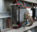 T8431C TMR analog input module with multiple colored wires and a metal connector inside a control panel